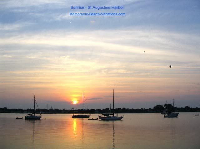 Florida St Augustine orange - blue - pink Sunrise clouds over Harbor with Sailboats + birds flying