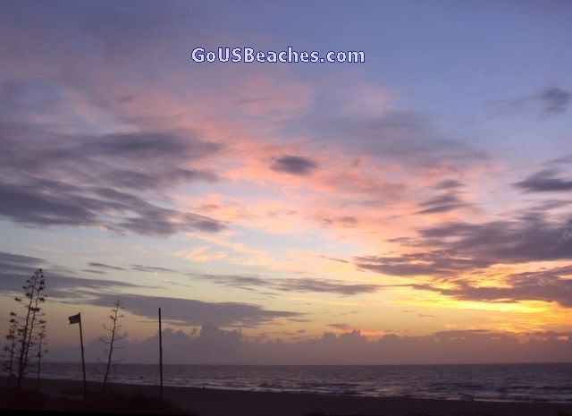 Colorful pink, orange and blue cloudy sunrise sky over ocean - Cocoa Beach, Florida 